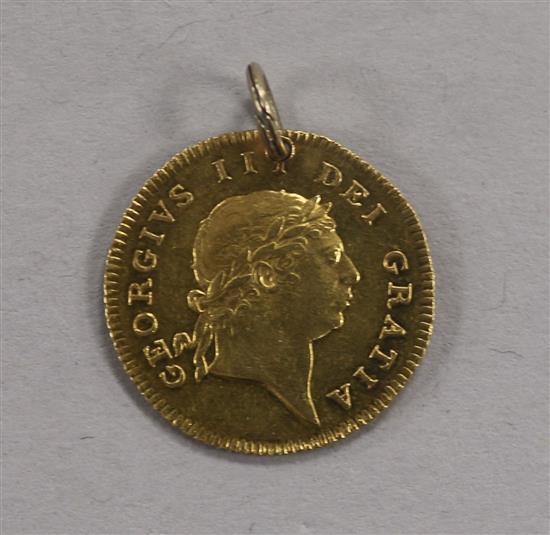 A George III gold half guinea, 1813, 4.4g gross, later pierced, with suspension loop